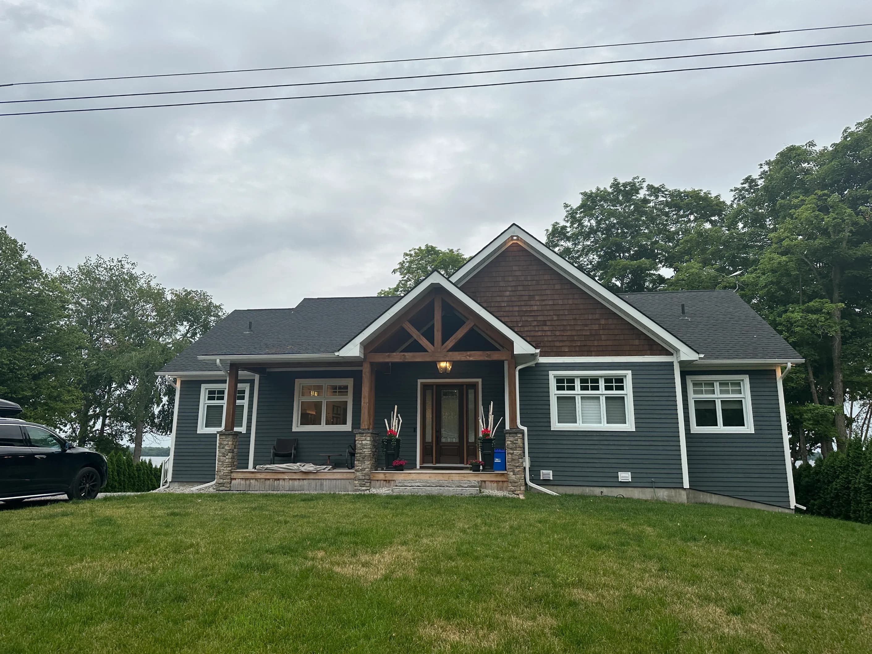 Cash home purchase, Calgary, Alberta Modern craftsman-style detached home with stone porch pillars in Calgary, Alberta — the kind of as-is property Canadian Home Buyers purchases for cash.